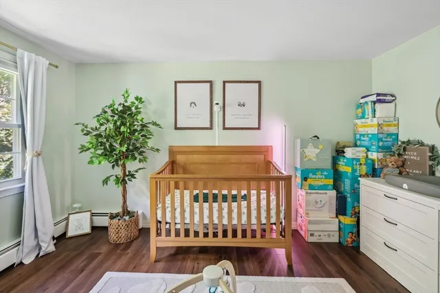 a bedroom with a bed and a potted plant