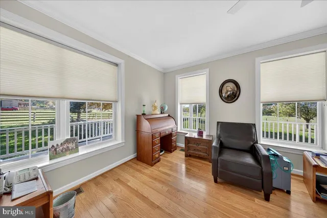 a bedroom with a bed a chandelier and a window