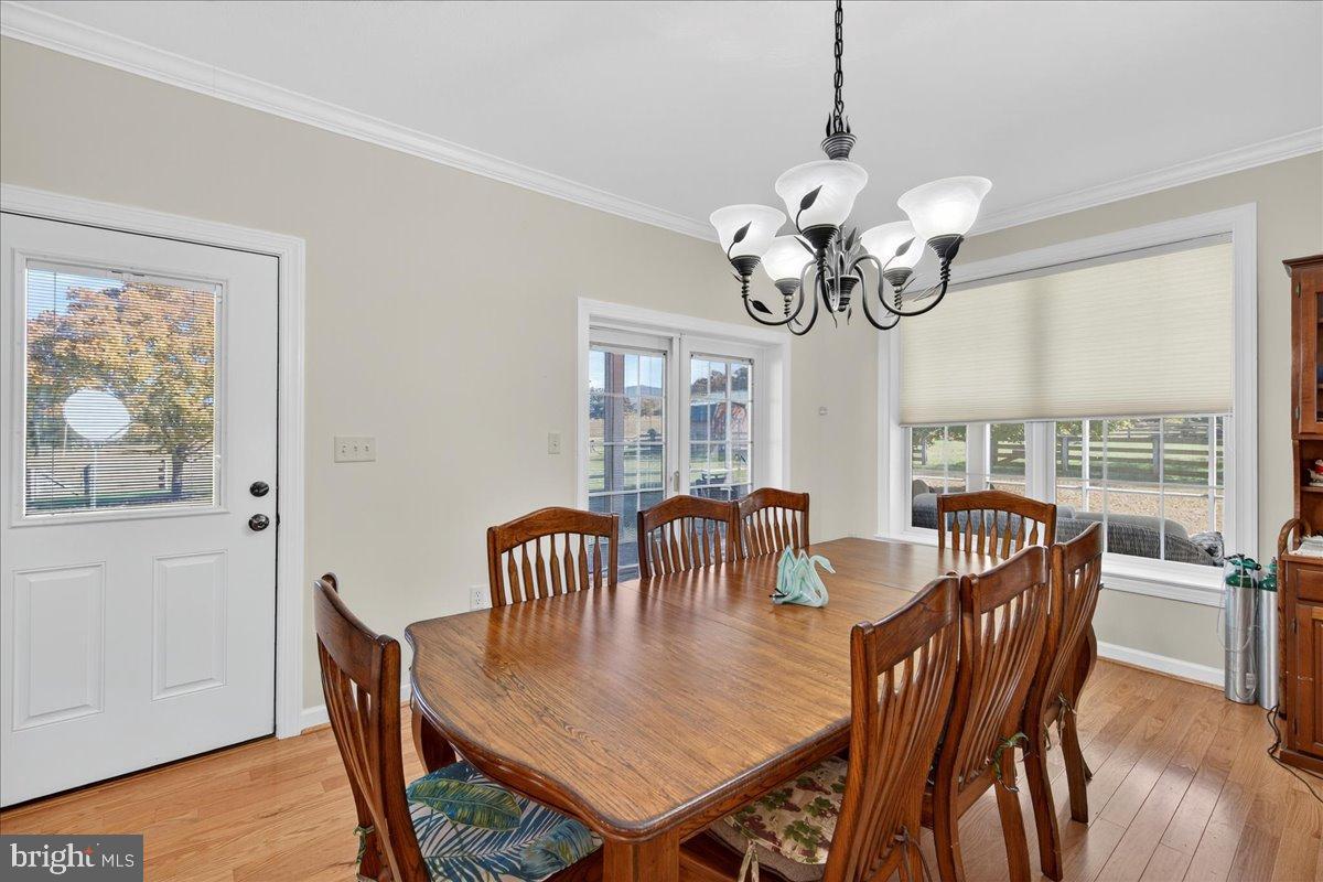 239 Mt Carmel Road Luray, VA 22835 - Photo 21 of 116 a view of a dining room with furniture wooden floor and chandelier