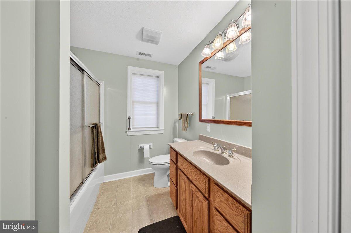 239 Mt Carmel Road Luray, VA 22835 - Photo 51 of 116 a bathroom with a sink a toilet a mirror and a window
