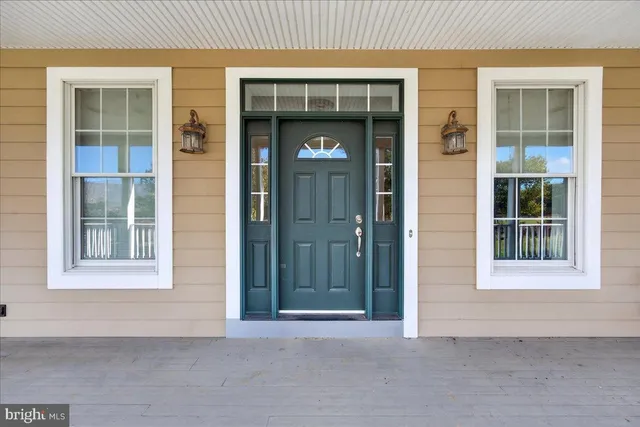 a view of a hallway with wooden floor and a hallway