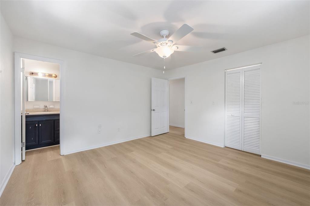 4825 Southwest 19th Street Gainesville, FL 32608 - Photo 16 of 40 a view of an empty room with a chandelier fan