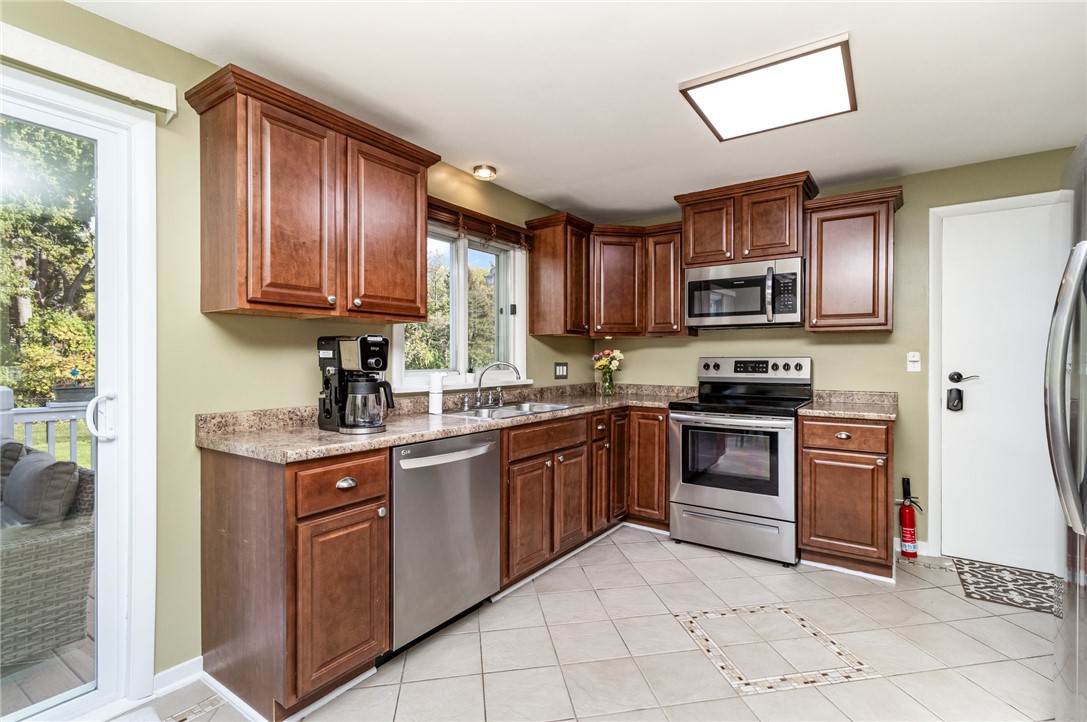 1282 Shoecraft Road Penfield, NY 14580 - Photo 11 of 29 Newer SS Appliances, Tile Floor, Cherry Cabinets