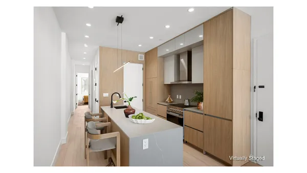 a kitchen with kitchen island cabinets a sink a stove and a refrigerator