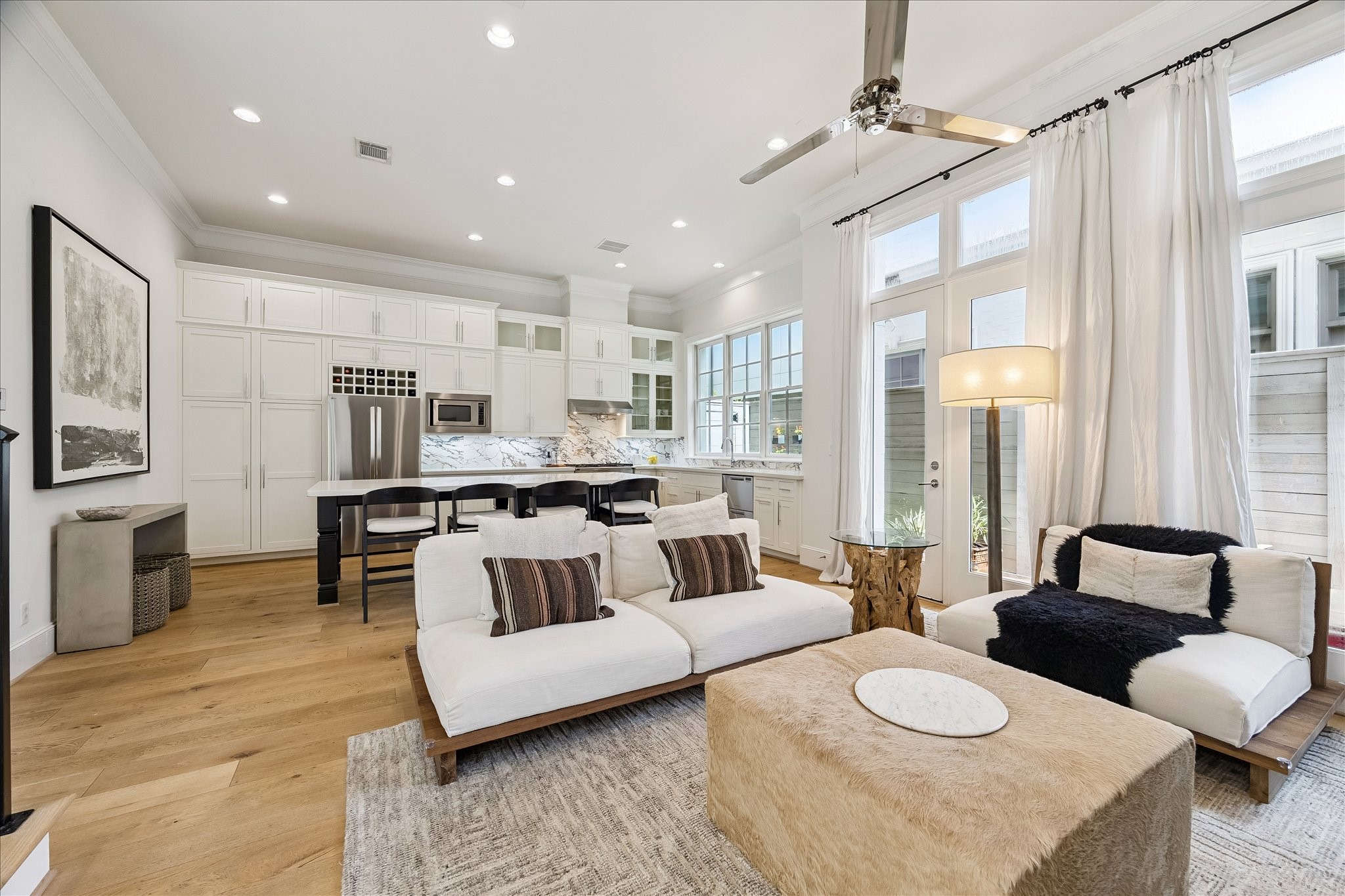 6108 Nicholas Grove Place Houston, TX 77055 - Photo 3 of 29 First-floor open living spaces with soaring 12' ceilings, punctuated with beautiful crown moulding and wide baseboards.