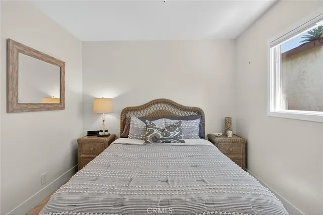 a bedroom with a bed and a night stand