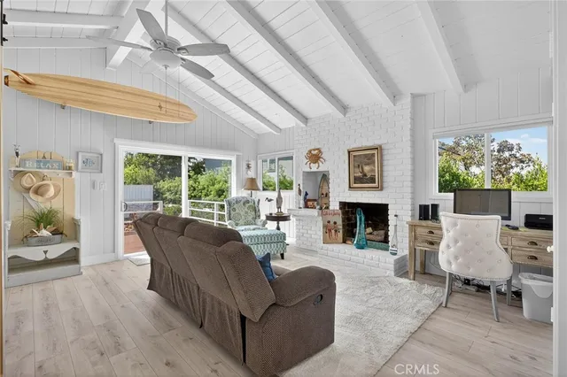 a living room with furniture a fireplace and a large window