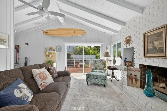 a living room with furniture a fireplace and a large window