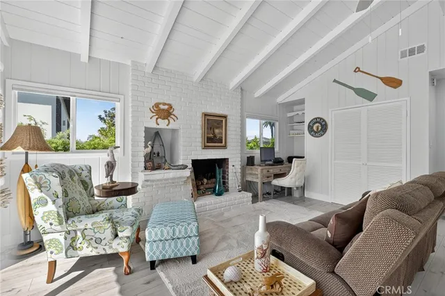 a living room with furniture a fireplace and a large window
