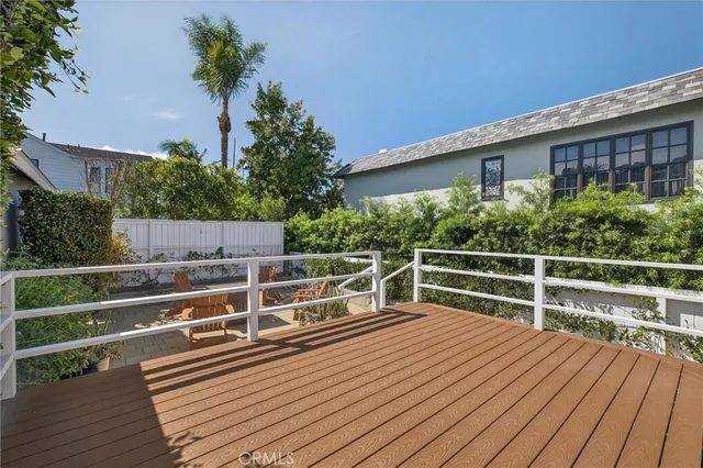 a view of a roof deck with wooden floor and fence
