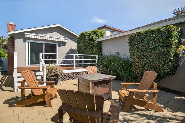 a view of a patio with table and chairs with wooden floor and fence