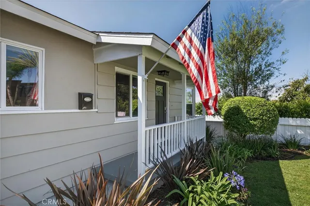 a view of a house with a small yard and plants