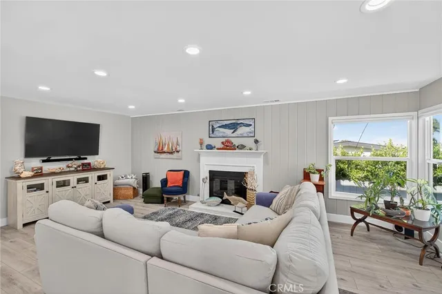 a living room with fireplace furniture and a flat screen tv