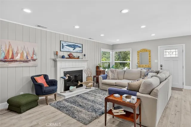 a living room with furniture a fireplace and a window
