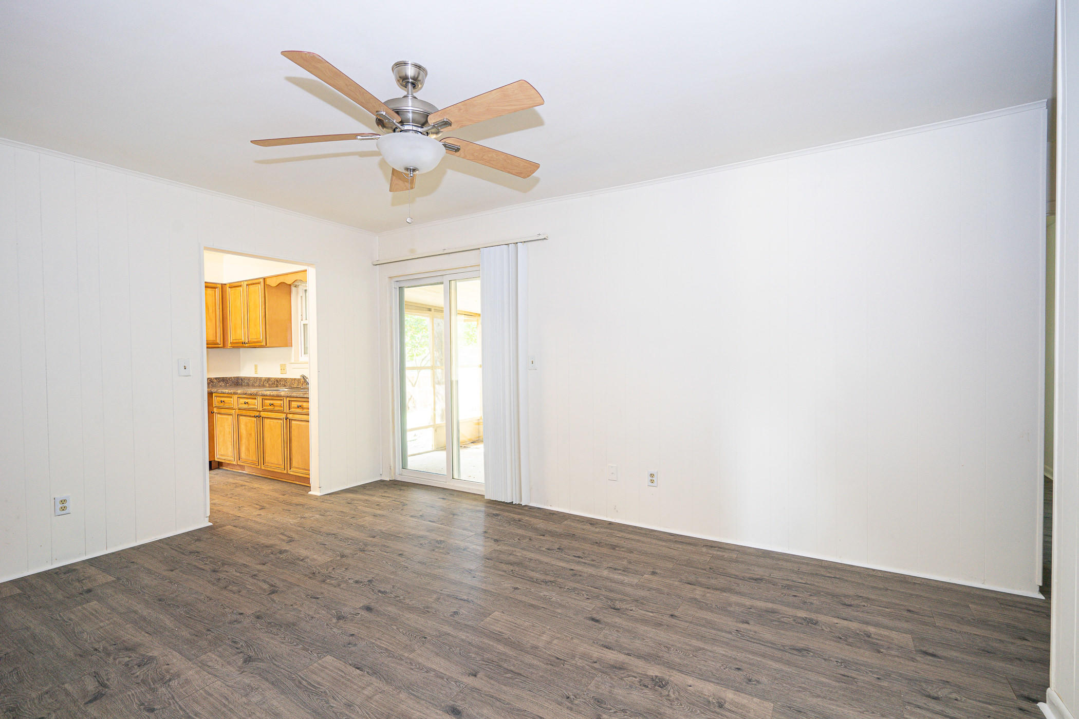 75 7th Street Shalimar, FL 32579 - Photo 17 of 19 a view of an empty room with wooden floor and a window