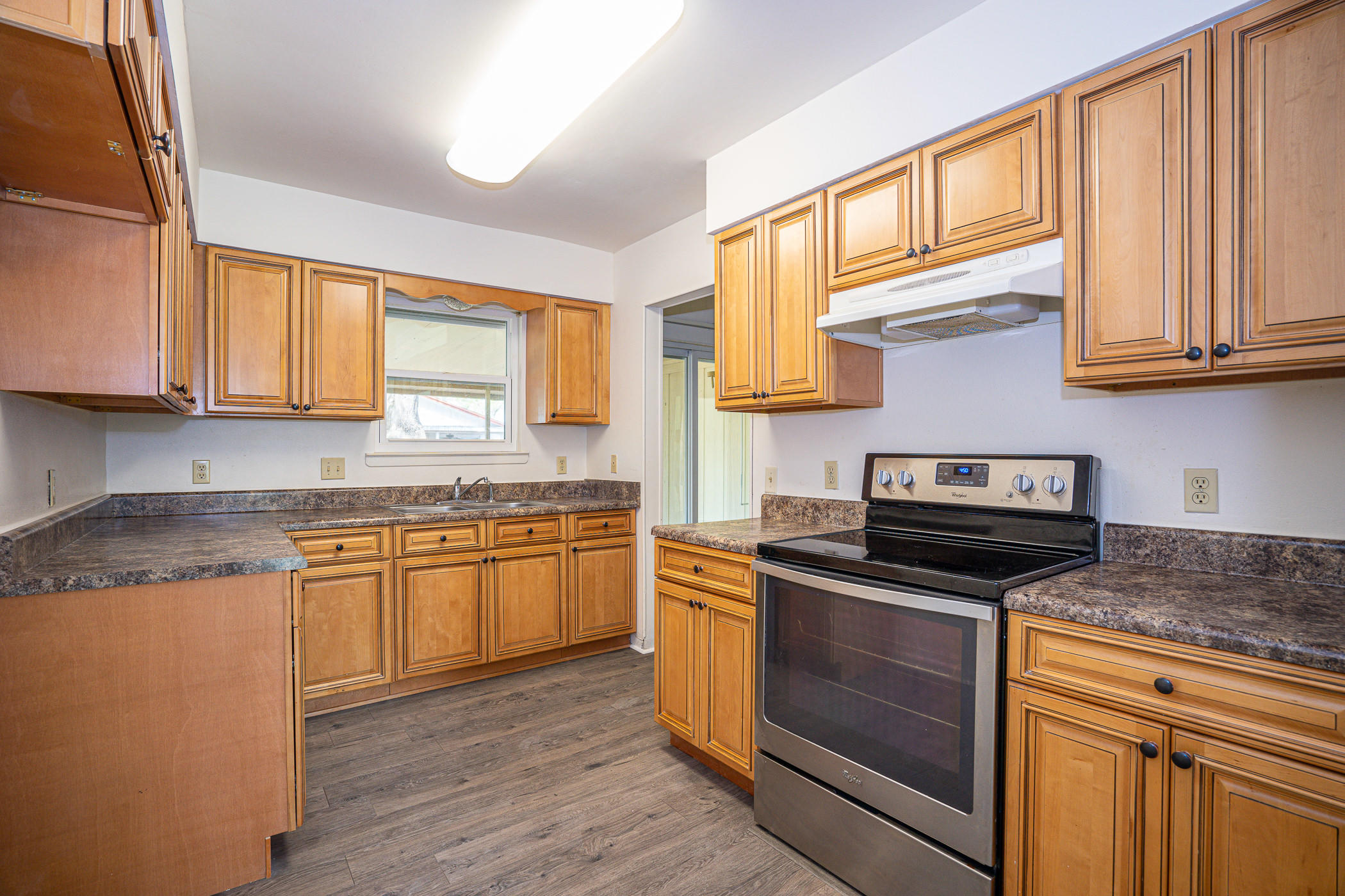 75 7th Street Shalimar, FL 32579 - Photo 8 of 19 a kitchen with granite countertop wooden cabinets stainless steel appliances and a window
