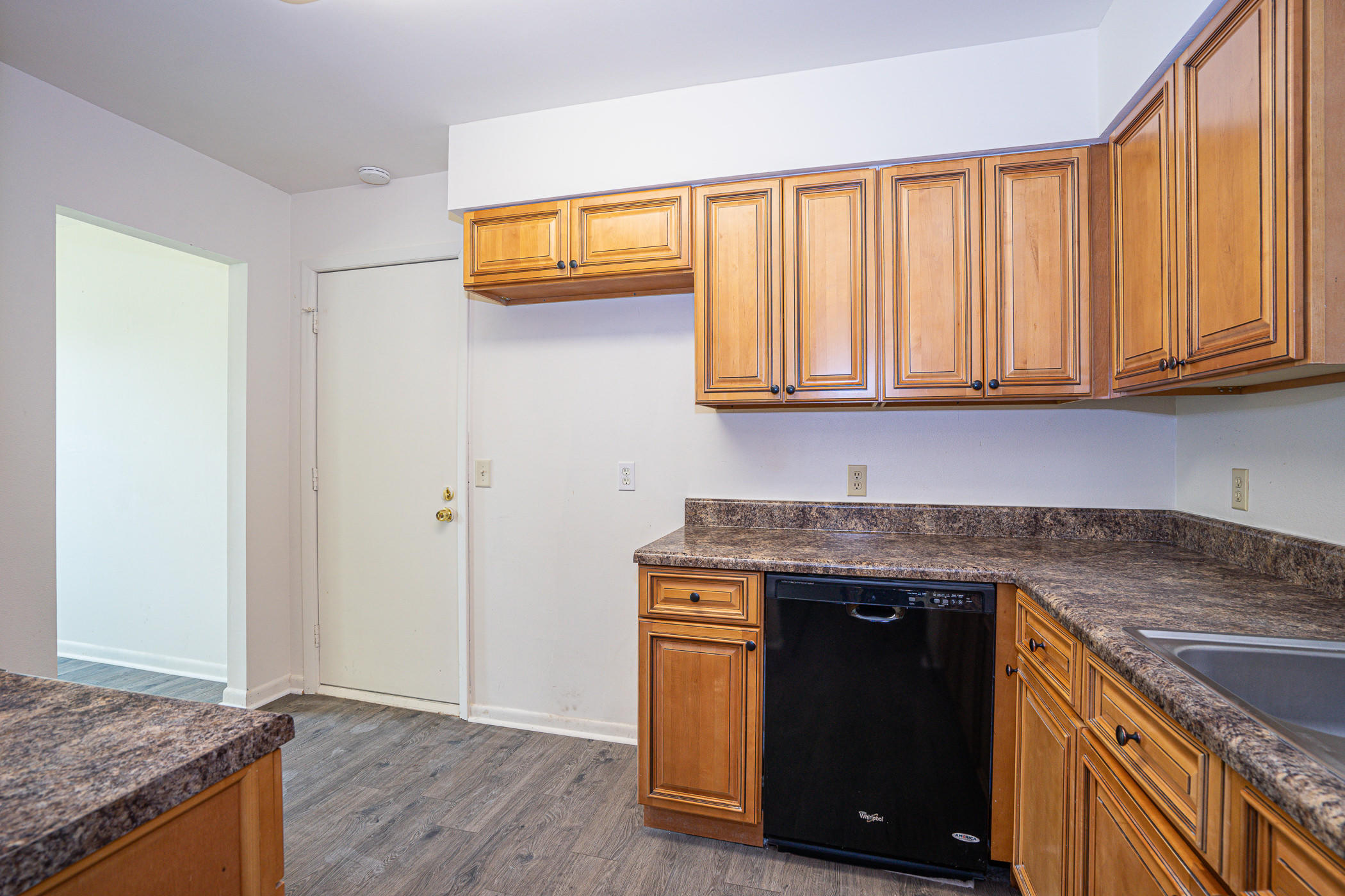 75 7th Street Shalimar, FL 32579 - Photo 9 of 19 a kitchen with granite countertop cabinets sink and wooden floor