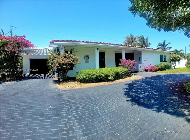 a front view of a house with yard and a garage