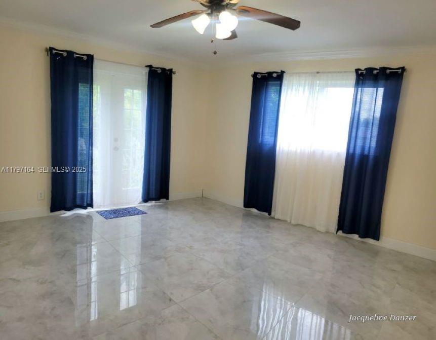 2241 Northeast 38th Street Lighthouse Point, FL 33064 - Photo 11 of 14 an empty room with closet and a chandelier fan
