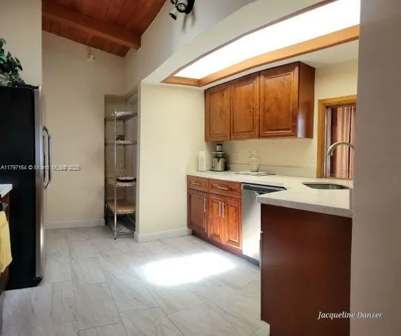 a kitchen with a sink and a refrigerator