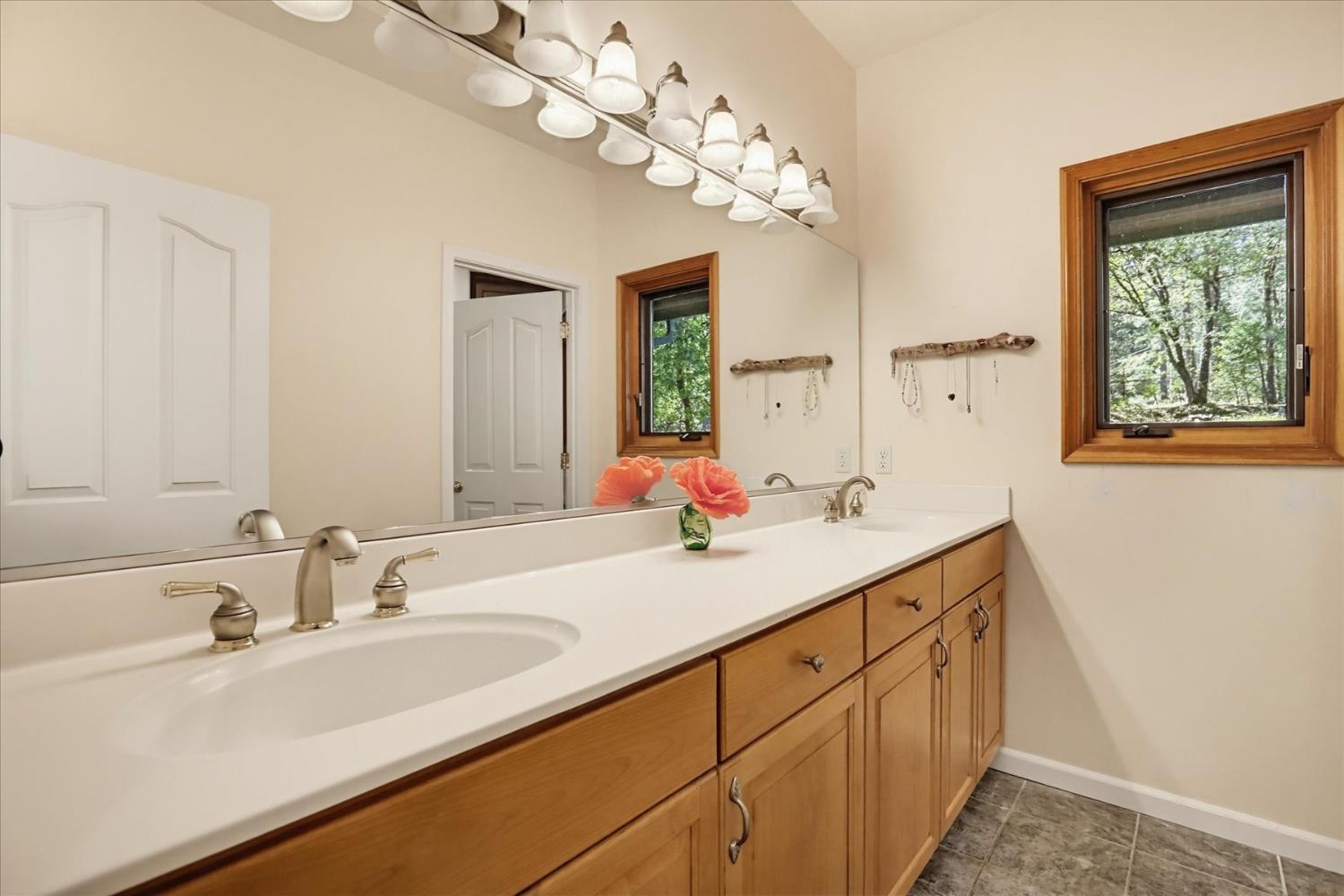 14517 North Bloomfield Road Nevada City, CA 95959 - Photo 29 of 78 a bathroom with a sink double vanity and a mirror
