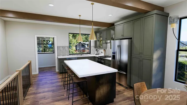 a kitchen with stainless steel appliances a refrigerator and a table