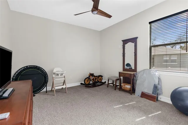 a bedroom with a bed a couch and a window