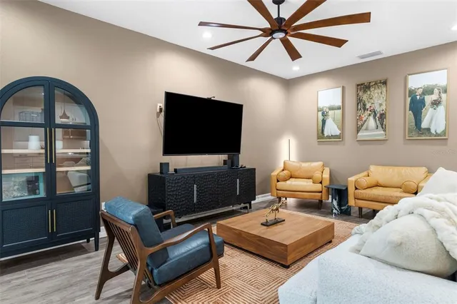 a living room with furniture a flat screen tv and a window