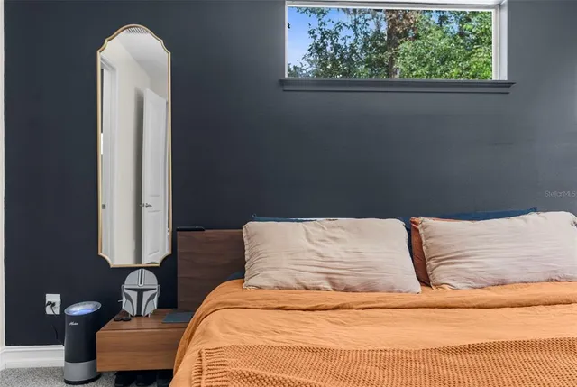 a bedroom with a bed and a window