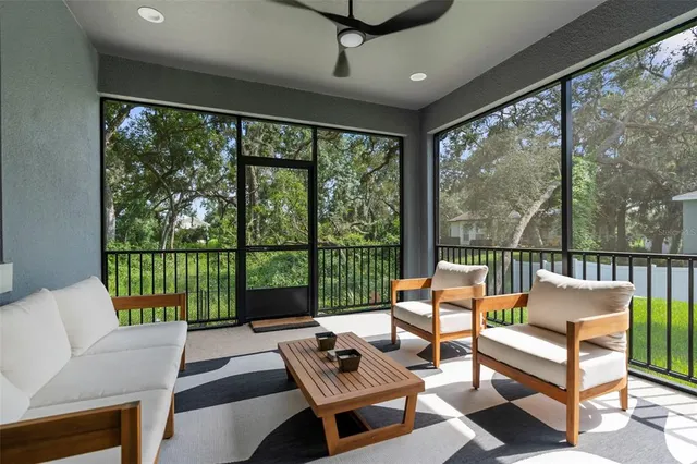 a living room with furniture and a floor to ceiling window