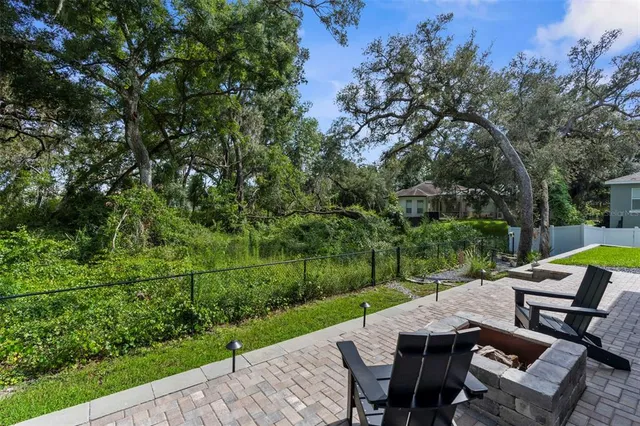 a view of backyard with seating area and green space