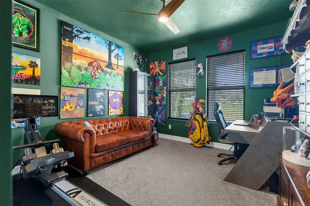 a blue bed sitting in a room next to a window