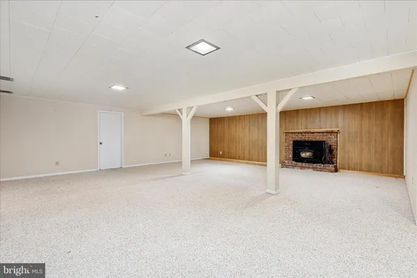 a view of empty room with a fireplace