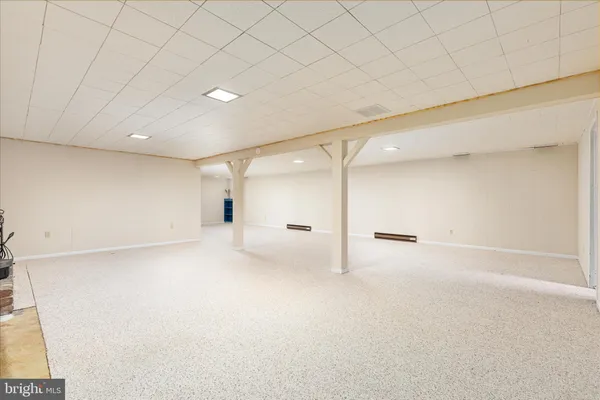 an empty room with a ceiling fan and window