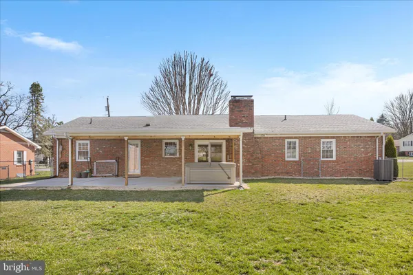 a front view of a house with a yard table and chairs
