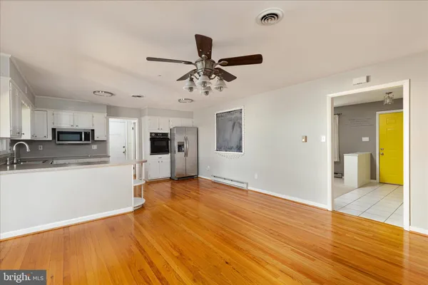 a view of a kitchen with a sink and a refrigerator