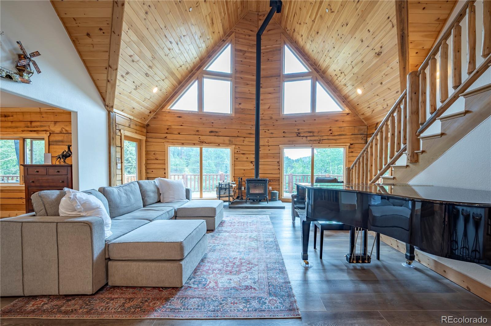 a living room with furniture a fireplace and a large window