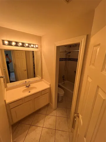 a bathroom with a tub a sink and a mirror