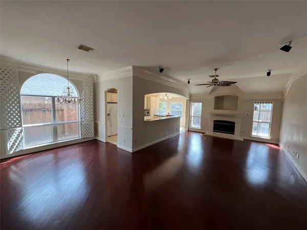 a large white kitchen with stainless steel appliances granite countertop a stove and a sink