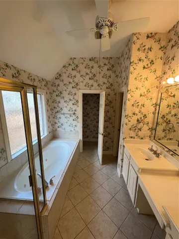 a bathroom with a bathtub and shower