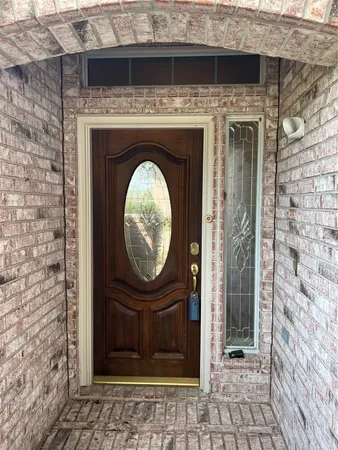 a view of a door of a house with wooden door