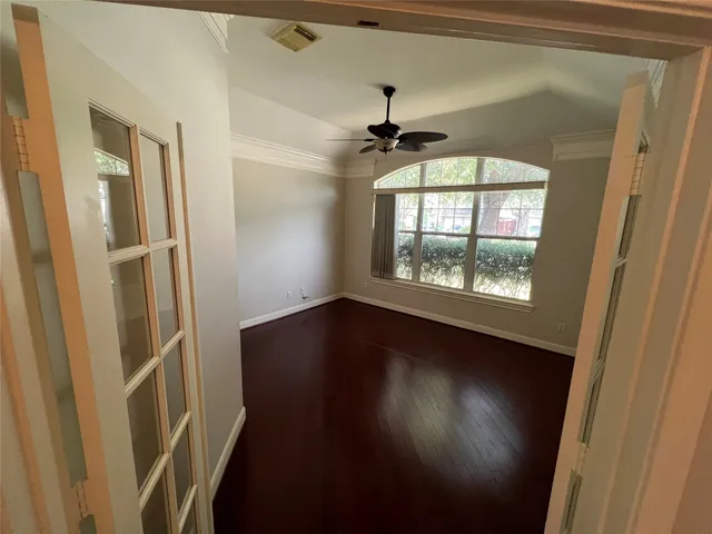 wooden floor in an empty room with a window