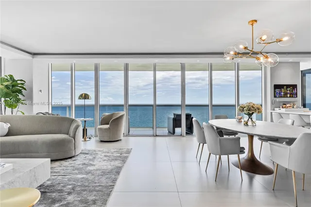 a living room with furniture and a floor to ceiling window