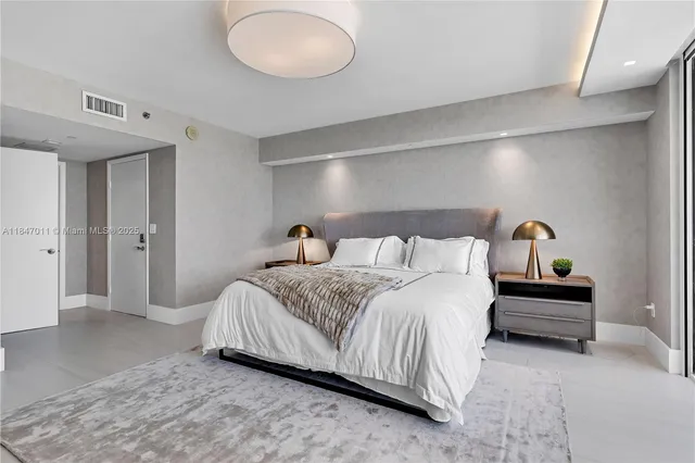 a bedroom with a bed and cabinets