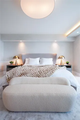 a bedroom with a bed and a lamp