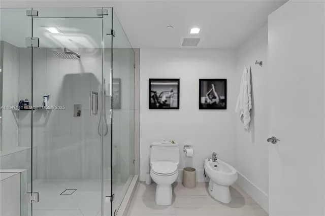 a bathroom with a toilet sink and shower