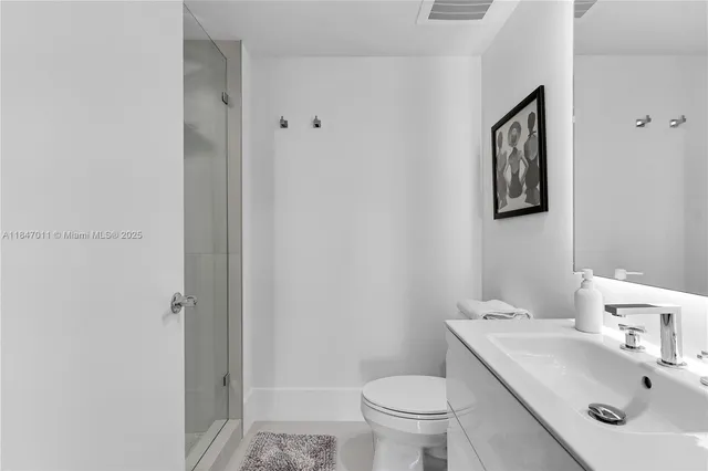 a bathroom with a sink toilet and a mirror