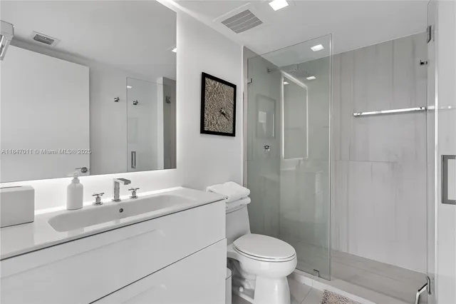 a bathroom with a sink toilet and shower