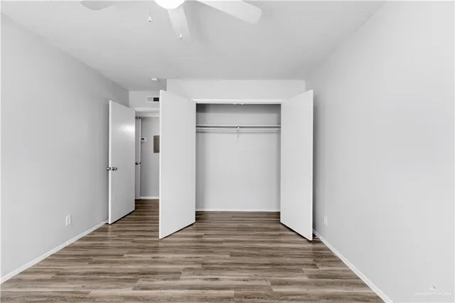 a view of a room with wooden floor