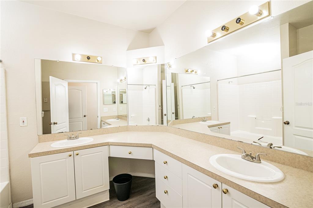 3391 South Kirkman Road, Unit 1216 Orlando, FL 32811 - Photo 20 of 33 a bathroom with a sink double vanity and a mirror